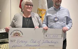 photo of Gayla Thunstrom presenting cheque to Robert Crouch, President of Rotary Club of Yellowknife